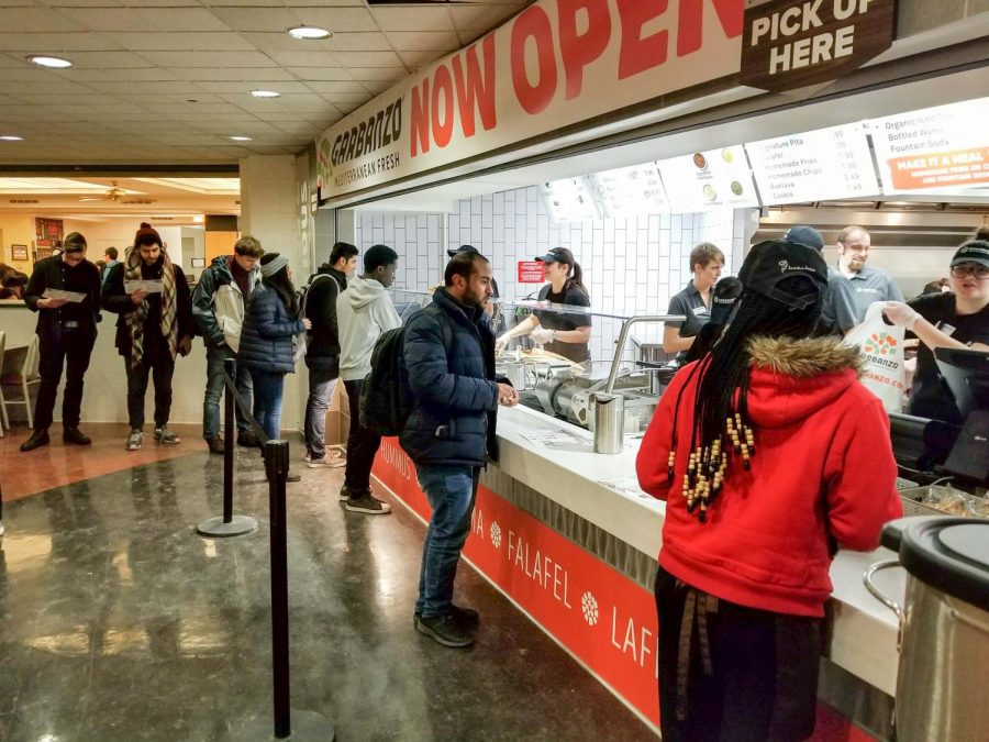 People order in line at Garbanzo in the basement of the Illini Union. The restaurant opened on Feb. 8, 2018.