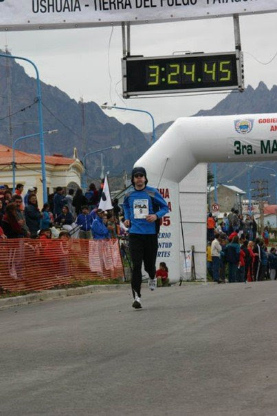 Professor Brian Gaines running over the finish line at the Fin del Mundo Marathon in Tierra del Fuego, Argentina, about a week after the Antarctica marathon, in 2005.