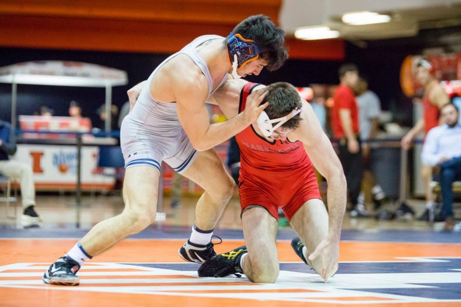 Illinois’ Isaiah Martinez wrestles with Maryland’s Brendan Burnham in the 165-pound weight class during the meet at Huff Hall on Jan. 28. The Illini won 25-18.