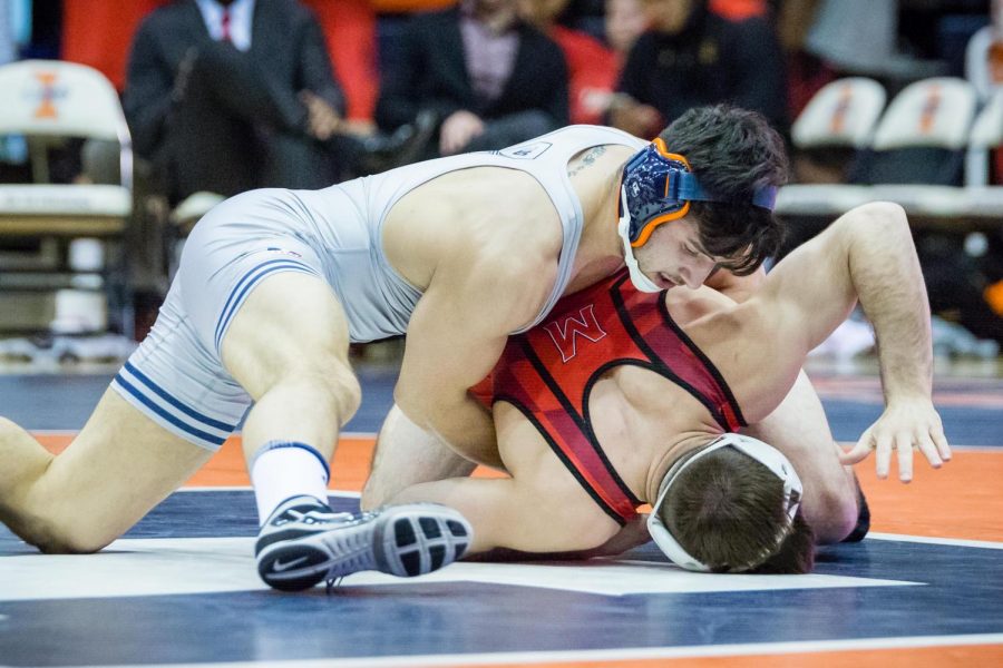 Illinois Isaiah Martinez wrestles with Marylands Brendan Burnham in the 165 pound weight class during the meet at Huff Hall on Sunday, Jan. 28, 2018. The Illini won 25-18.