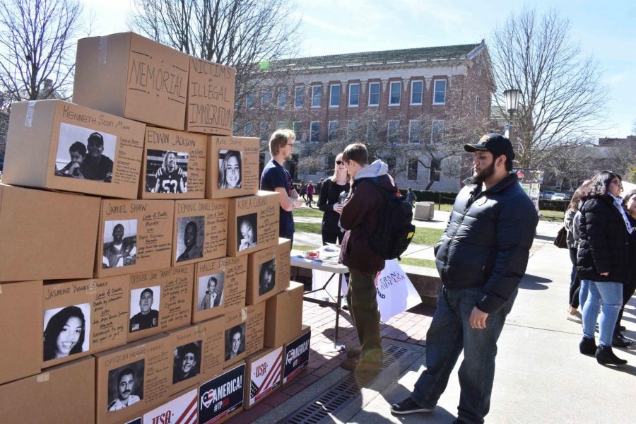 A student examines the Wall for Victims demonstration by Turning Point USA on the Main Quad on Mar. 15.
