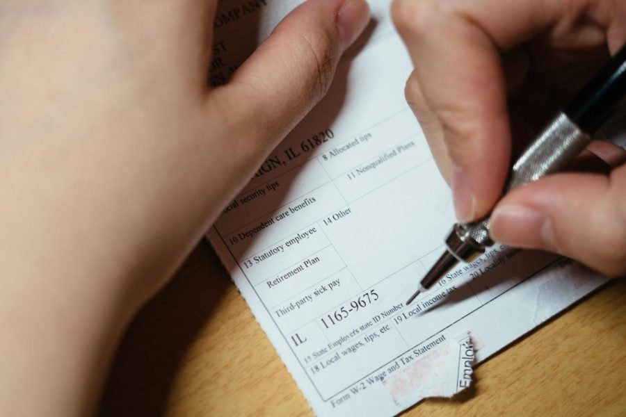 A student fills out the W-4 tax form.