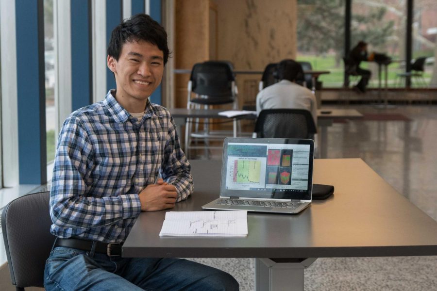 Goldwater scholarship recipient Michael Toriyama poses with his research in Loomis Laboratory of Physics.  In his research, Toriyama conducts simulations of ion radiation in semiconductors.