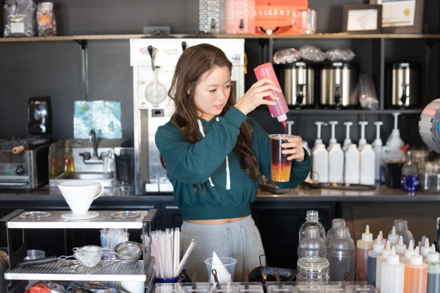 Christine Ahn, co-owner of Hammerhead Coffee and junior at
the University, prepares a drink on Thursday