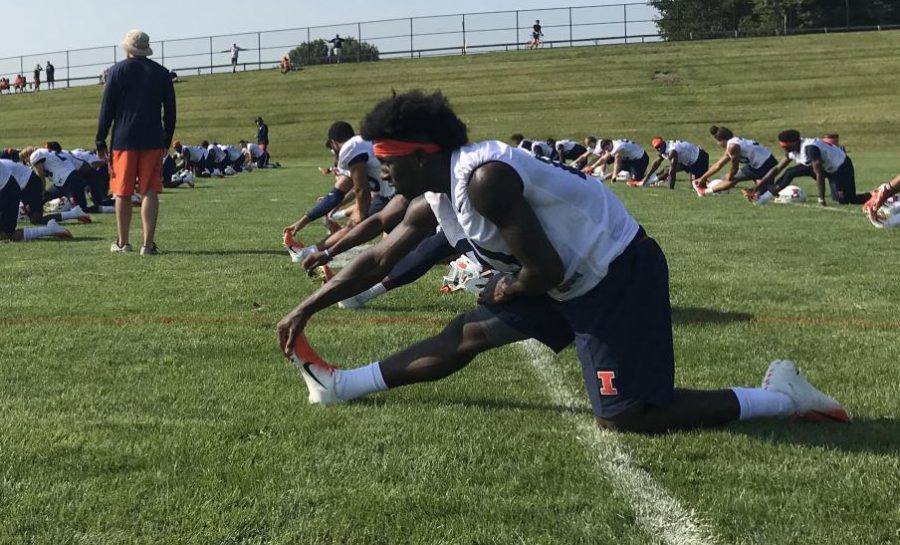 Freshman+defensive+back+Jartavius+Martin+stretches+with+his+teammates+before+the+second+day+of+practice+at+the+Illinois+football+training+camp+at+the+Campus+Recreation+fields+on+Saturday.+The+Illini+are+looking+to+improve+both+offensively+and+defensively+in+the+upcoming+season%2C+with+players+working+hard+and+striving+to+prove+their+place+on+the+team.