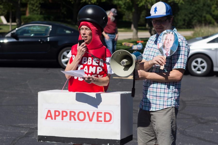 Ellen Leyerle, a Champaign resident, dressed as a rubber stamp to criticize Rep. Rodney Davis’ support for President Trump’s
policies while she spoke at a rally outside Davis’ Champaign office. 