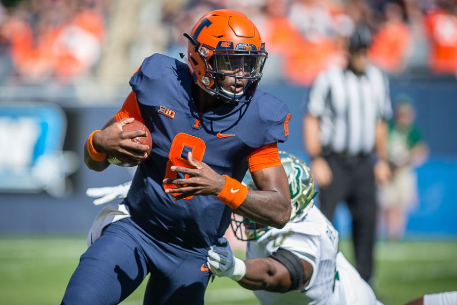 Illinois quarterback M.J. Rivers II (8) dodges a tackle during the game against USF at Soldier Field on Saturday, Sept. 15, 2018.