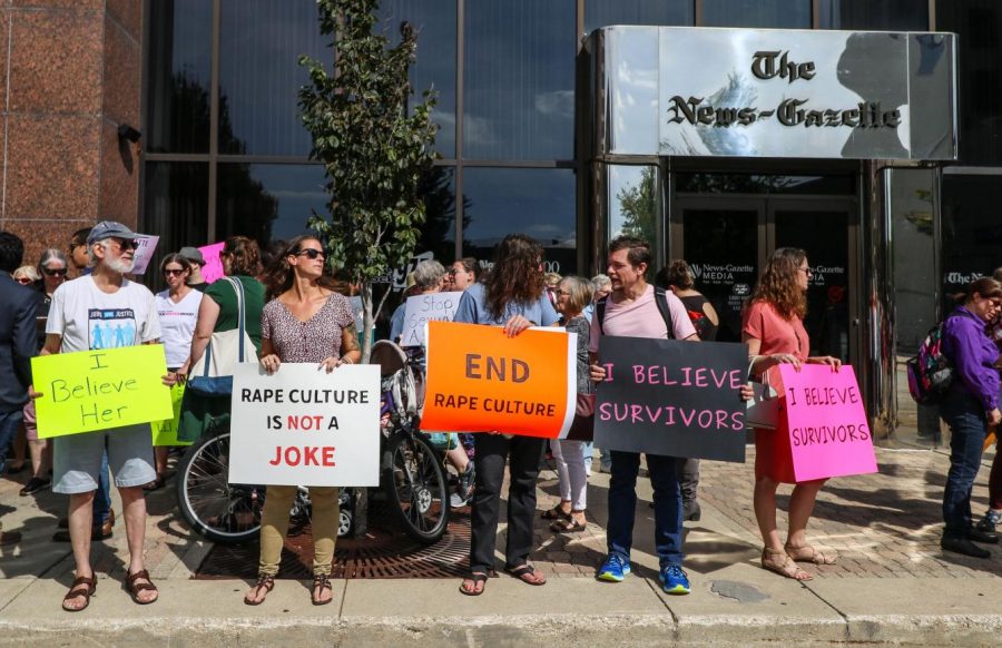 Protesters stand outside The News Gazette on Oct. 1, 2018.