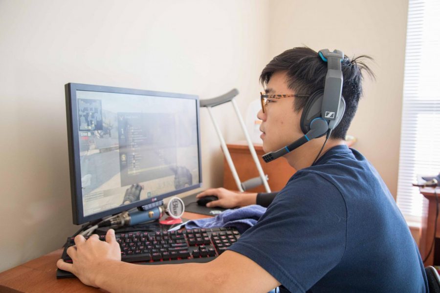 Danny Yoo, in game leader for the Illini Esports Orange Counter Strike: Global Offensive team, plays a match of the game on his computer.