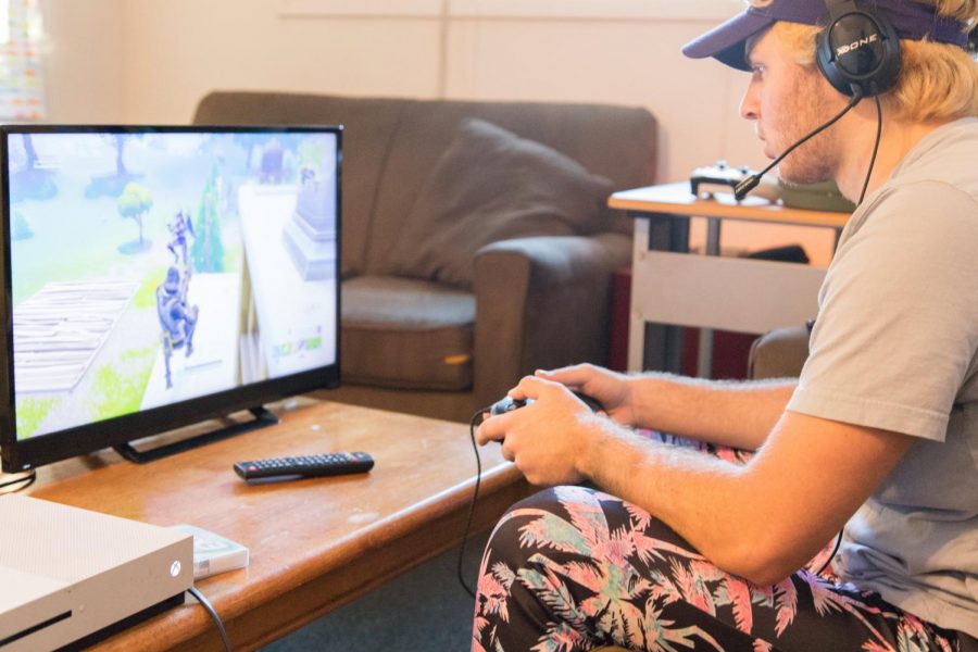 Mike Hoke plays a game of Fortnite in his apartment on Saturday. 