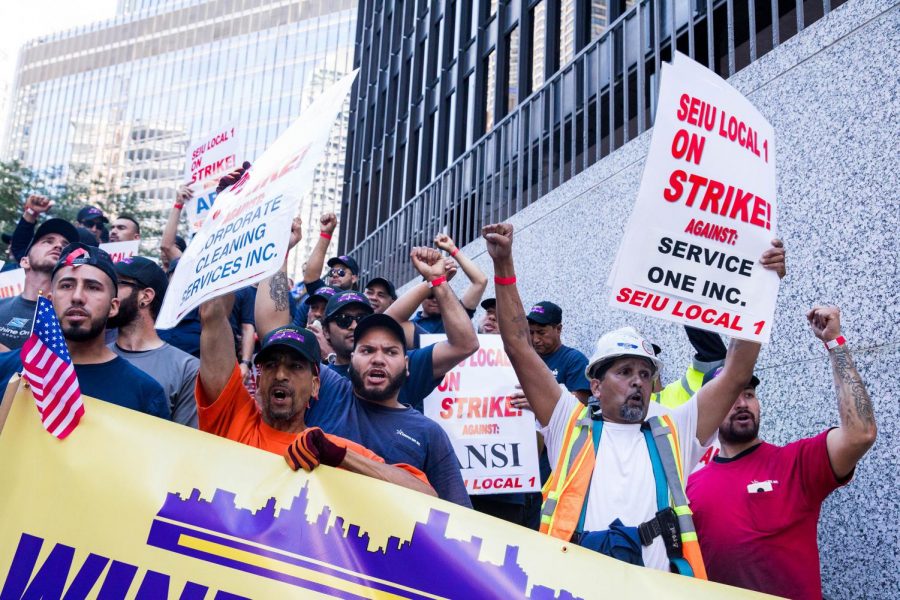 Window washers chant during a march in Chicago on July 2. Workers demanded better insurance and higher pay for window-washing services.