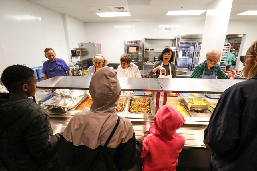 Volunteers distribute food at the Daily Bread Soup Kitchen on Wednesday. 