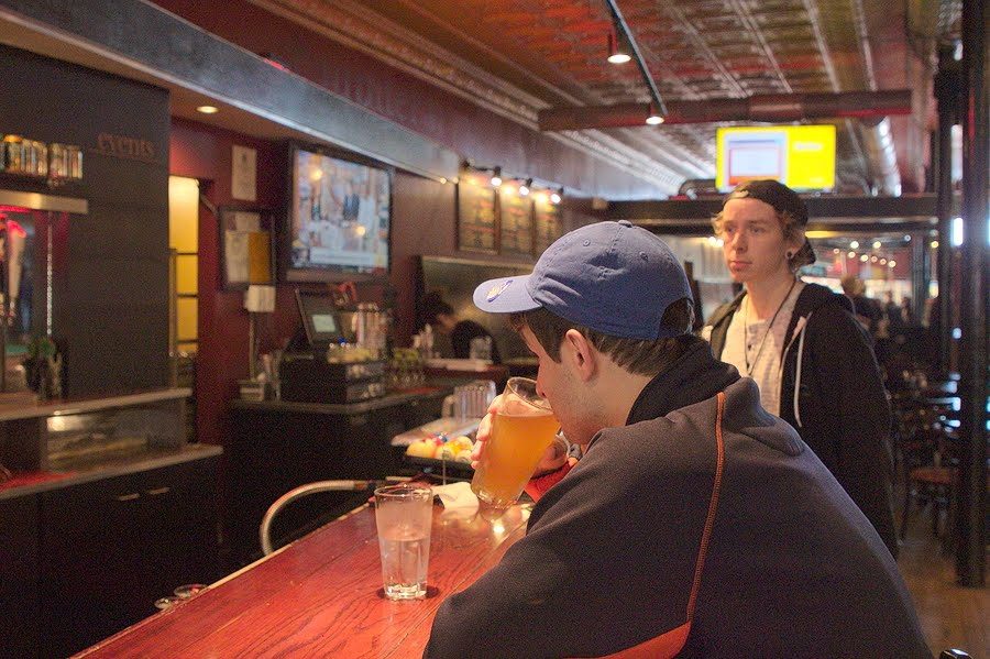 Local resident Jacob Carter and Allan Hay sit at the bar at Jupiter’s Pizzeria and Billiards, located in downtown Champaign, on Oct. 11. The University was ranked No. 7 in top ten college towns, citing Jupiter’s as one of the city’s iconic pizza places. 