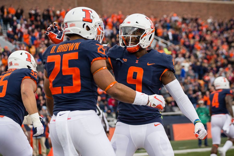 Illinois running back Dre Brown (25) celebrates with wide receiver Sam Mays (9) after scoring a touchdown during the game against Minnesota at Memorial Stadium on Saturday, Nov. 3, 2018.