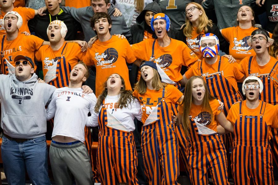 Members of the Spike Squad student section sing “Hail to the Orange” during a break in the match against Penn State at Huff Hall on November 10. The Illini won 3-2.