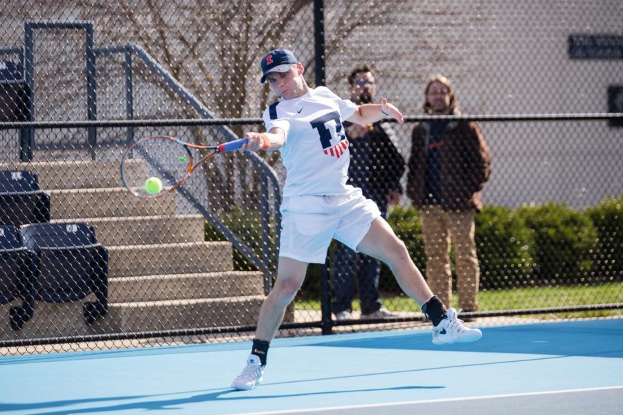 Junior Zeke Clark serves the ball during a match. The mens tennis team boasts several powerful duos in fast-paced doubles matches, leaving plenty to look out for this season.
