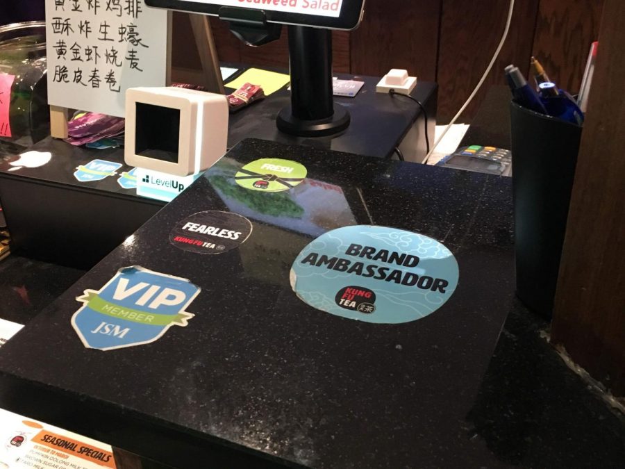 A Brand Ambassador sticker is placed on the counter near the register at Kung Fu Tea, located at 707 S 6th St. in Champaign. 