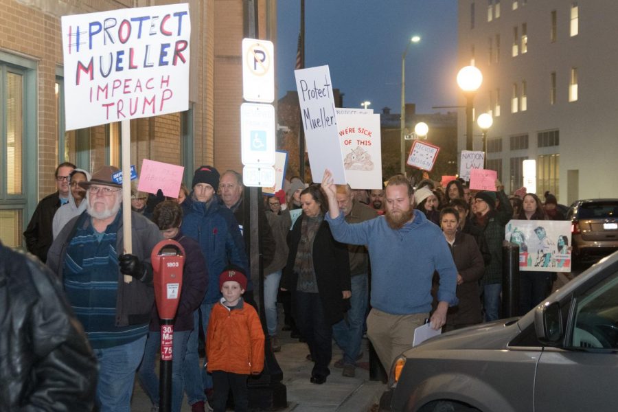 Protesters march through downtown Champaign on Thursday in response to President Trumps decision to replace Rod Rosenstein with Acting Attorney General Matt Whitaker as the head of the Mueller probe.  The Nobody is Above the Law protest was previously organized so that if President Trump were to replace the oversight of the special counsel, a rapid response series of protests would take place the next day.