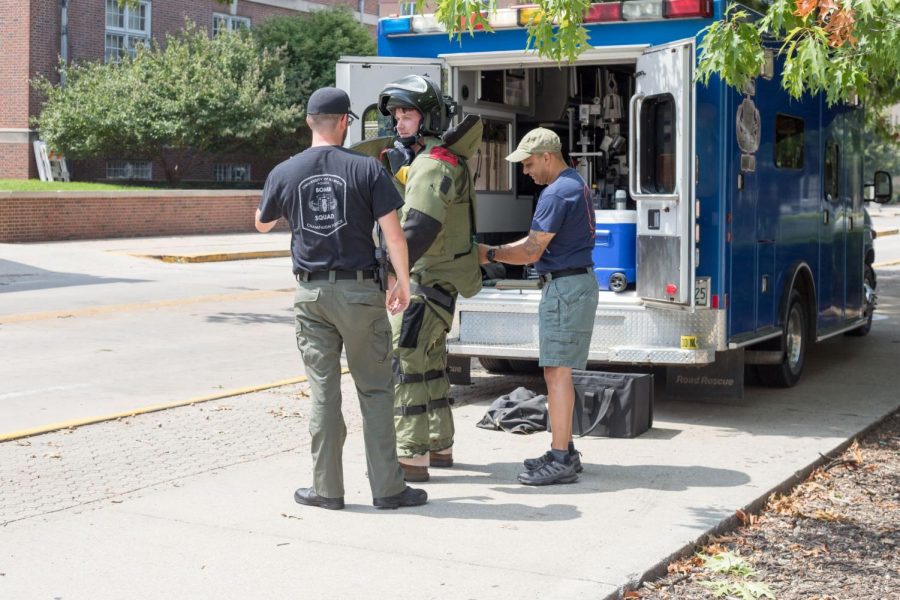 A member of the bomb squad suits up to address a suspicious package left on the 1100 block of Sixth Street on Aug. 26.
