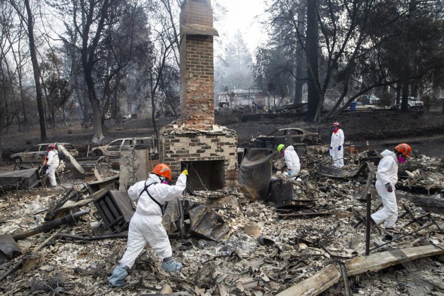 Search and rescue teams inspect the grounds of a house burned down by the Camp Fire along Boquest Boulevard on Nov. 17 in Paradise, California. University students from the area stay updated
from afar as their family and friends recover.