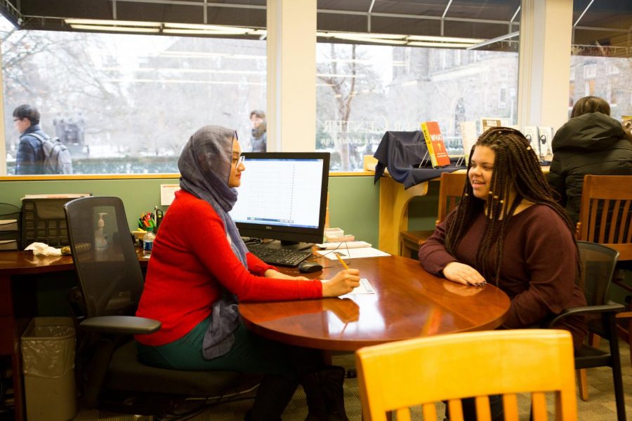 Shoptorshi Rahman (left) and Alexis Young (right) walk through a sample resume at the Career Center on Thursday.