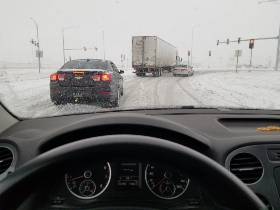 Cars drive along snow-covered roads during the snowstorm that battered the Midwest this past weekend. Columnist Noah writes that while snow in the Midwest is nothing new, some people still tend to jump at the first sign of potentially bad weather.