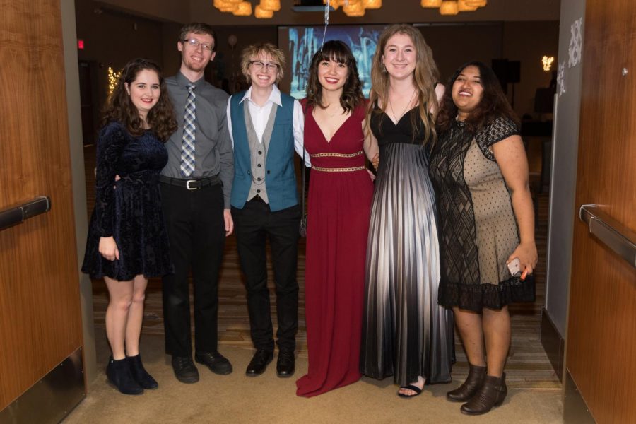 Yule Ball attendees (from left to right) Becca Sullivan and Aryk Sullivan pose with students Kai Wiest, Holly Miller, Clair Markuson and Apurva Chakravorty, who are working the door. The third annual Yule Ball took place at the I Hotel Conference Center on Jan. 19.