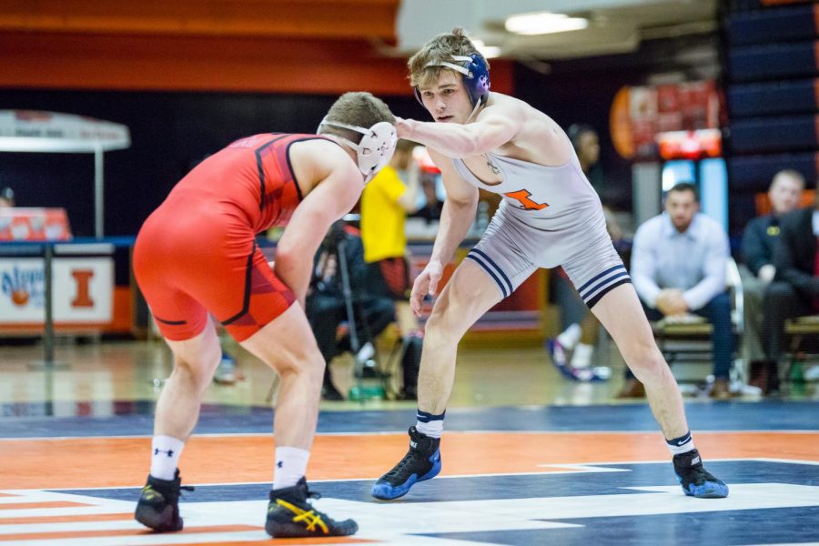 Illinois’ Travis Piotrowski wrestles with Maryland’s Brandon Cray in the 125-pound weight class during the meet at Huff Hall on Jan. 28. The Illini won 25-18.