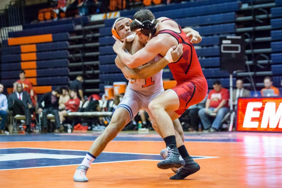 Illinois’ Emery Parker wrestles with Maryland’s Niko Capello in the 184-pound weight class during the meet at Huff Hall on Jan. 28. The Illini won 25-18.