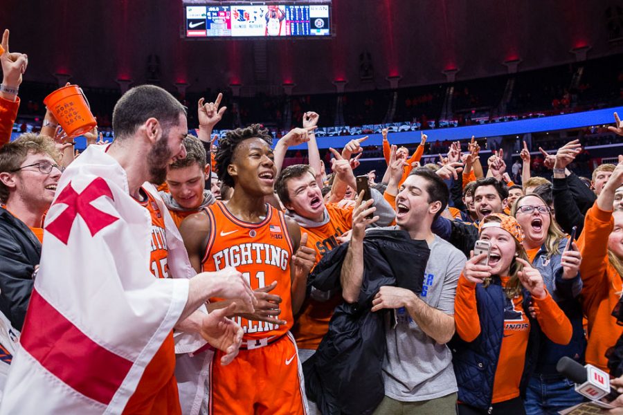 Students celebrate with guard Ayo Dosunmu and forward Giorgi Bezhanishvili after their post-game interview after the game against Michigan State at State Farm Center on Tuesday. The Illini defeat the Spartans 79-74.