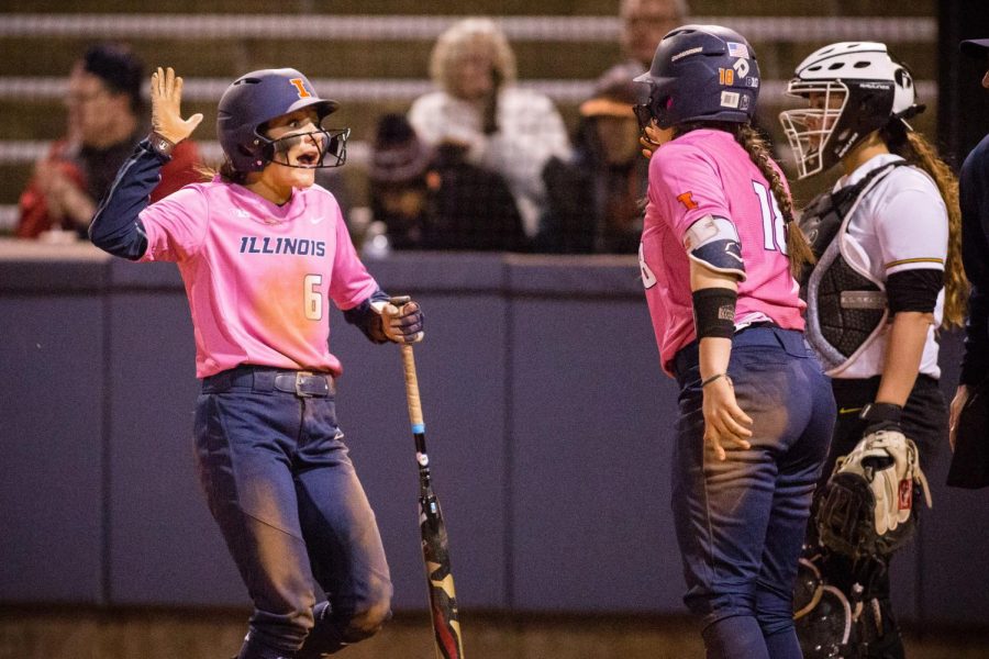 Illinois outfielder Kiana Sherlund (left) celebrates with catcher Bella Loya (right) after scoring a run in the bottom of the seventh to make the score 5-5 against Iowa at Eichelberger Field on April 21. The Illini won 6-5. Sherlund and Loya are excited to start the new season and build on their skills. 