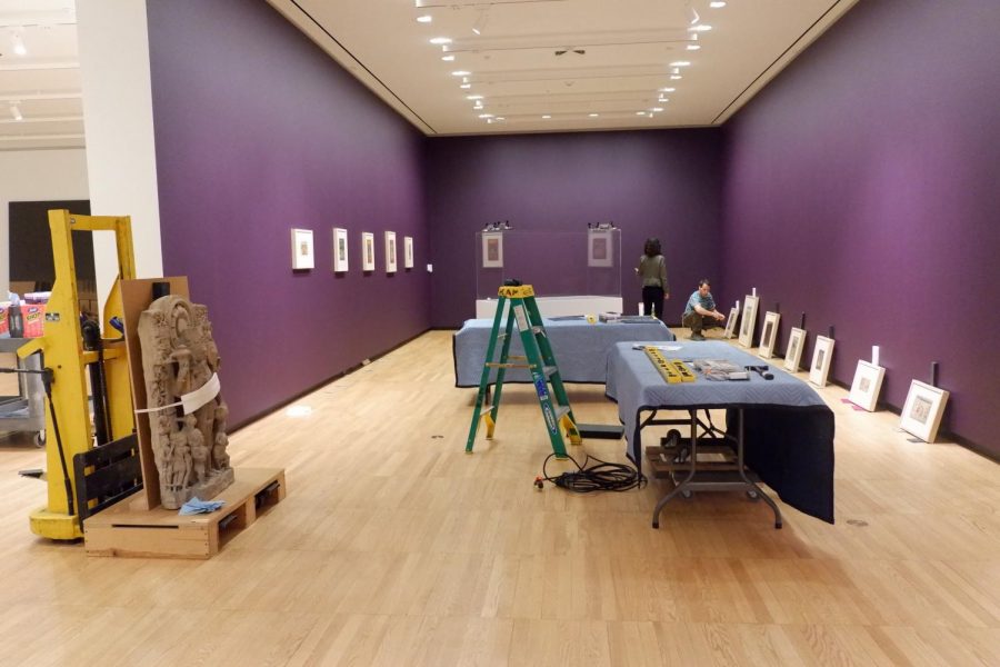 Allyson Purpura (Senior curator) and Tim Fox (Design and installation specialist) installing the Hand to Hand: Painting and the Animation of History in Northern India exhibit at Krannert Art Museum. 02/21/19.