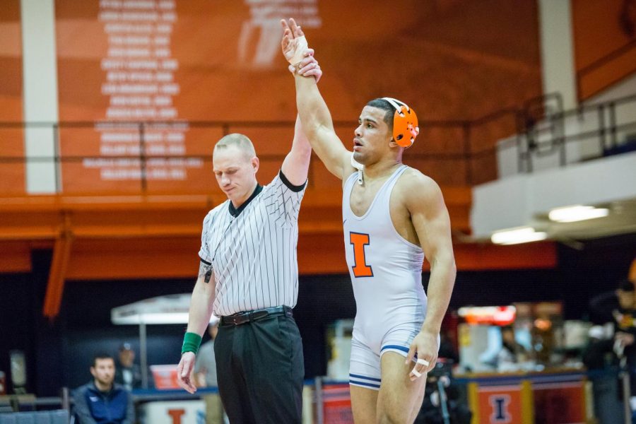 Illinois Emery Parker is declared the winner against Marylands Niko Capello in the 184 pound weight class during the meet at Huff Hall on Sunday, Jan. 28, 2018. The Illini won 25-18.
