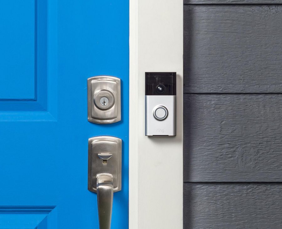 The Ring video doorbell, mounted next to the front door of a house.