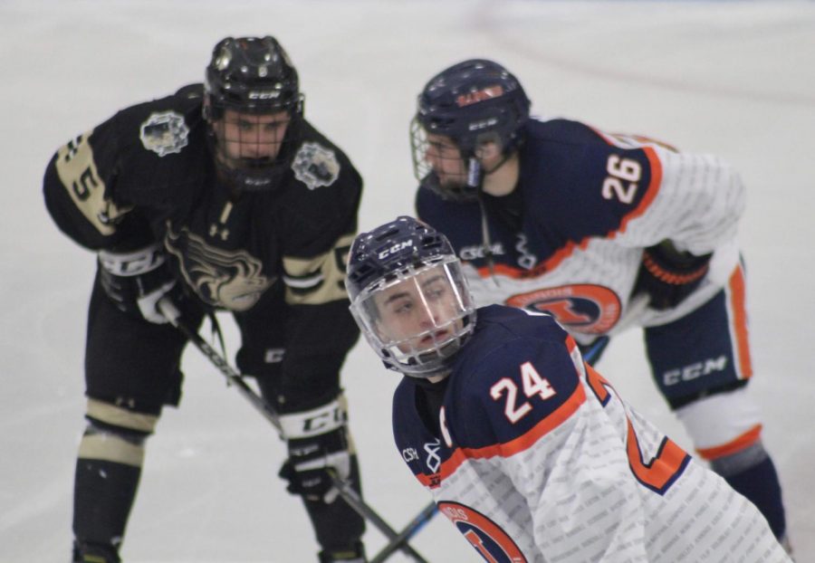 Illinois forwards Bobby Ernsting (front) and Thomas Kolaz (back) face off with a Lindenwood player during the Illinois vs. Lindenwood game at the Ice Arena on Jan. 18. Illinois lost 2-1. 