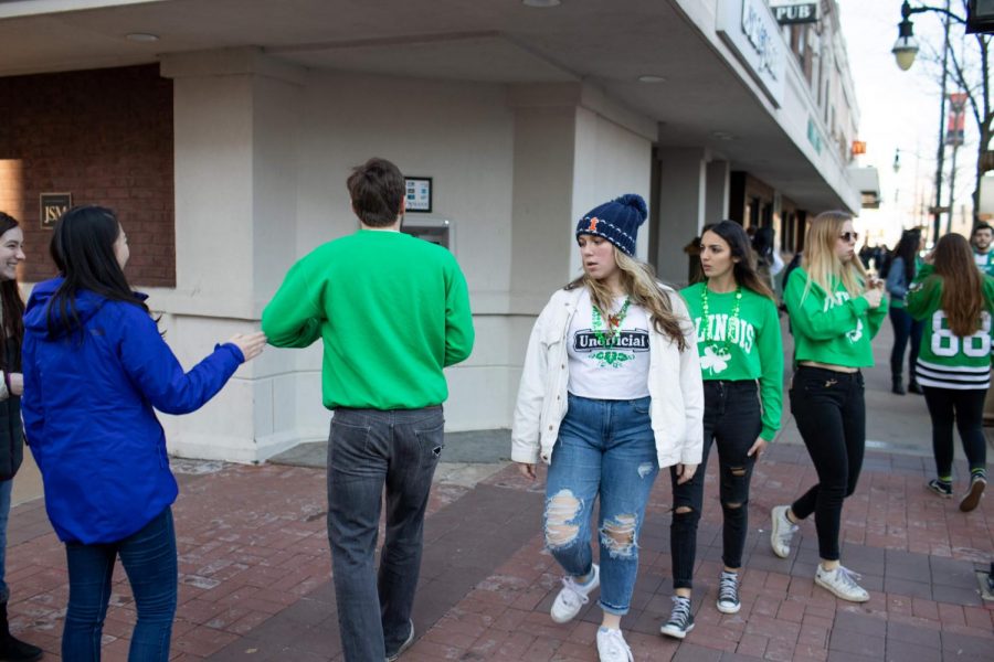 Celebrators walk along Green Street during Unofficial on Friday.
