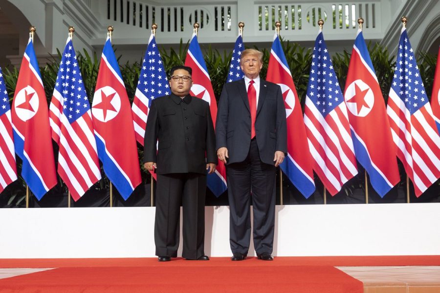 Kim and Trump standing next to each other on the red carpet during the Singapore summit
