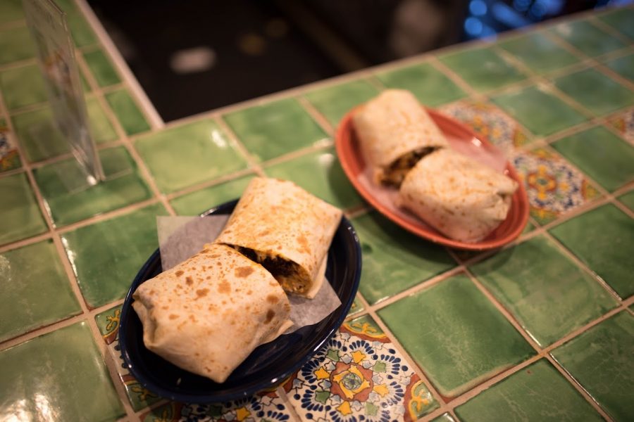 Burritos made by the chefs at Maize Mexican Grill are placed on the counter inside the restaurant on Sunday.