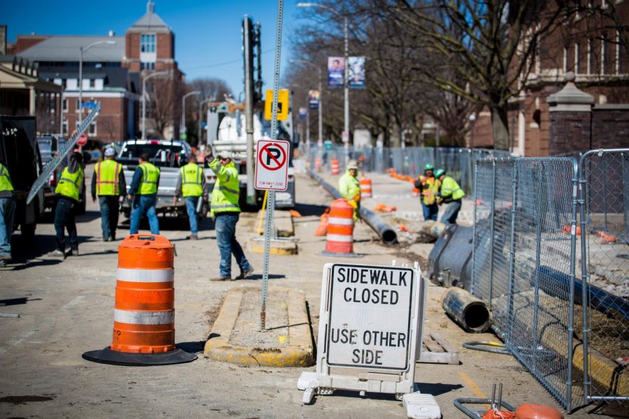 Construction workers on Wright Street on Tuesday. The east side of the street between Daniel and Armory streets is closed to pedestrians.