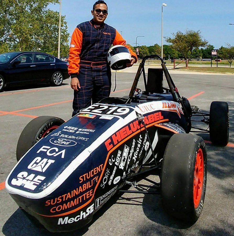 Shreyas Dmello stands in front of one of the formula electric cars he helped build. The Illini Formula Electric team has allowed Dmello to apply what he learned in the classroom.