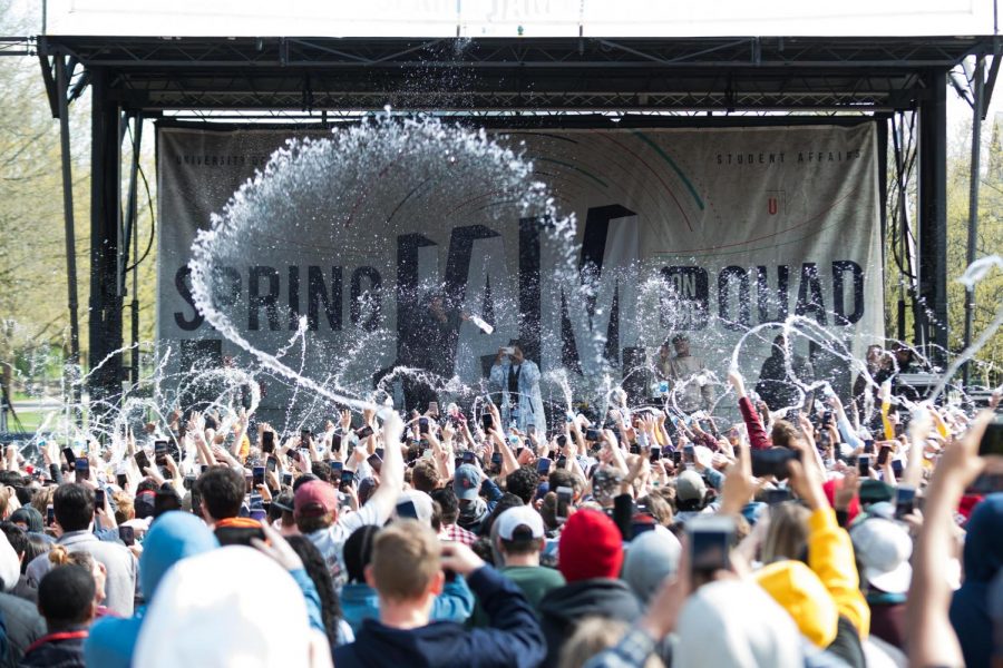 The crowd throws water toward the Spring Jam stage on the Main Quad on Sunday.