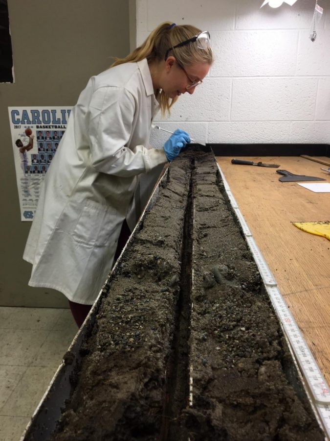 Katherine Braun samples soil cores in the laboratory as part of her research on shoreline erosion.