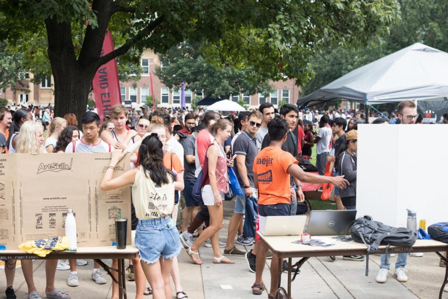 Students walk past Quad Day tables along the Main Quad representing a variety of registered student organizations on Aug. 26. While joining is fun, it’s easy to overcommit yourself.