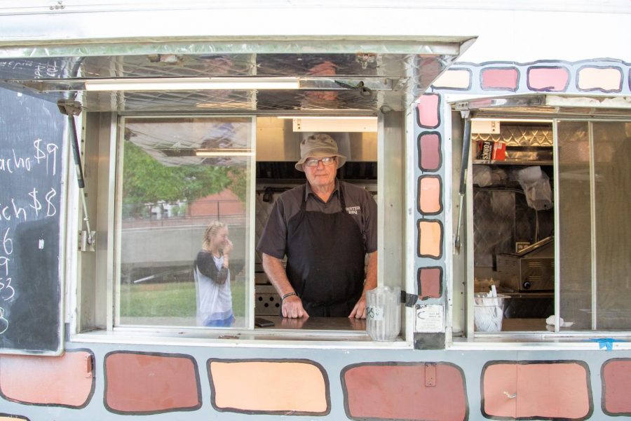 Brian Chester, employee at Chester’s BBQ food truck, stands inside the food truck on Thursday. Food trucks have become part of the landscape of C-U, which international students can explore.