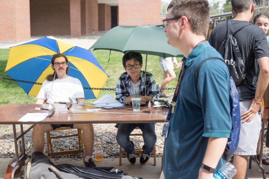Representatives of the Classical Fencing Registered Student Organization sit at their booths as people walk by exploring the Quad during Quad Day Aug. 26. Keep in mind the people working on Quad Day are people, too.