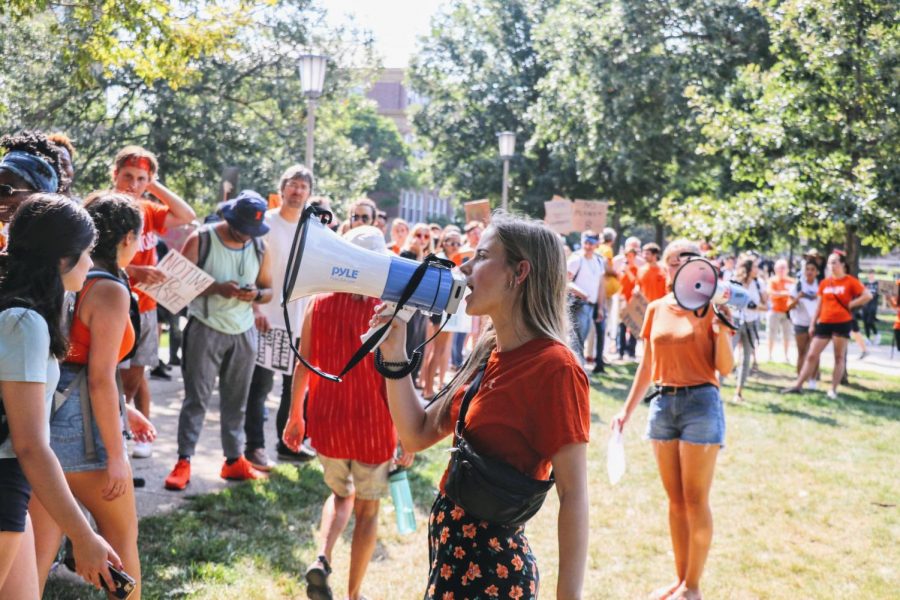 A student rallies participants of the climate change march on Sept. 20. Students and members of the local community gathered to join in protesting the government’s lack of influence in combating climate change. 
