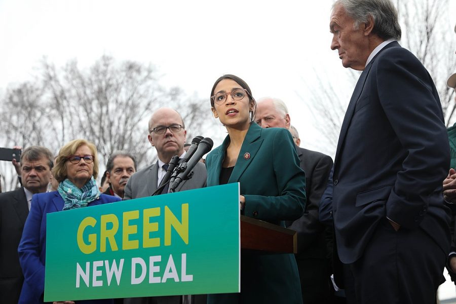 Representative Alexandria Ocasio-Cortez (center) speaks on the Green New Deal with Senator Ed Markey (right) in front of the Capitol Building in February. Columnist Andrew urges the public to recognize the asymmetric polarization of the partisan system.