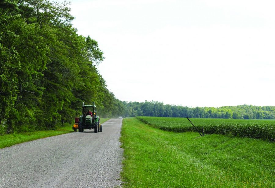 A tractor drives down County Road 450 E. in Monticello on Sept. 6. Columnist Ellen urges students to recognize the beauty of the Midwest.