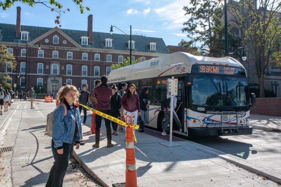 University students disembark from the 9B Brown bus at the new Wright Street bus island on Friday. The northbound 1 Yellow, 13 Silver, 22 Illini, 9 Brown, 4 Blue and 5 Green buses have been running on Wright Street since Sept. 24.