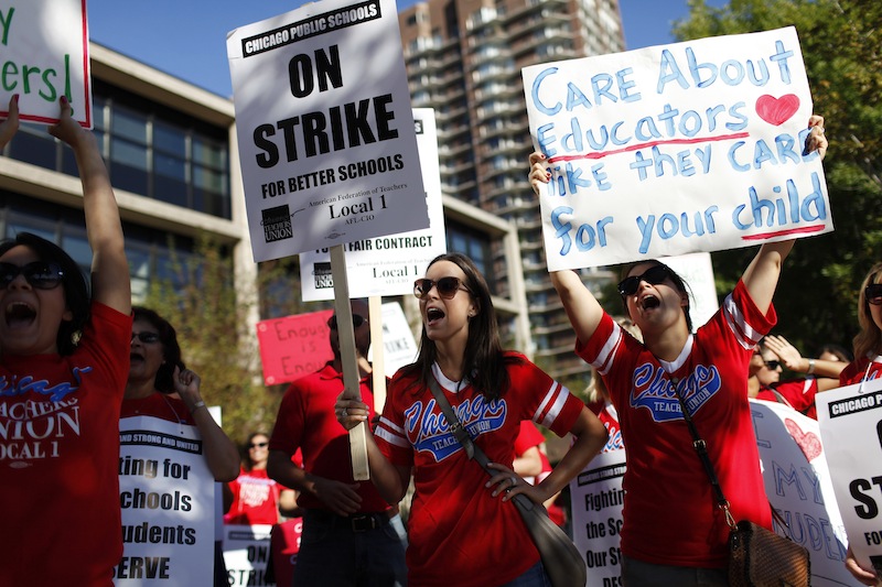 Teachers with the Chicago Teachers Union picket outside of the Walt Disney Magnet School in Chicago on Sept. 10, 2012. Columnist Skylar argues adding to the education budget won’t solve problems on its own. 